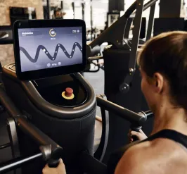 Woman standing at YMCA EGYM machine